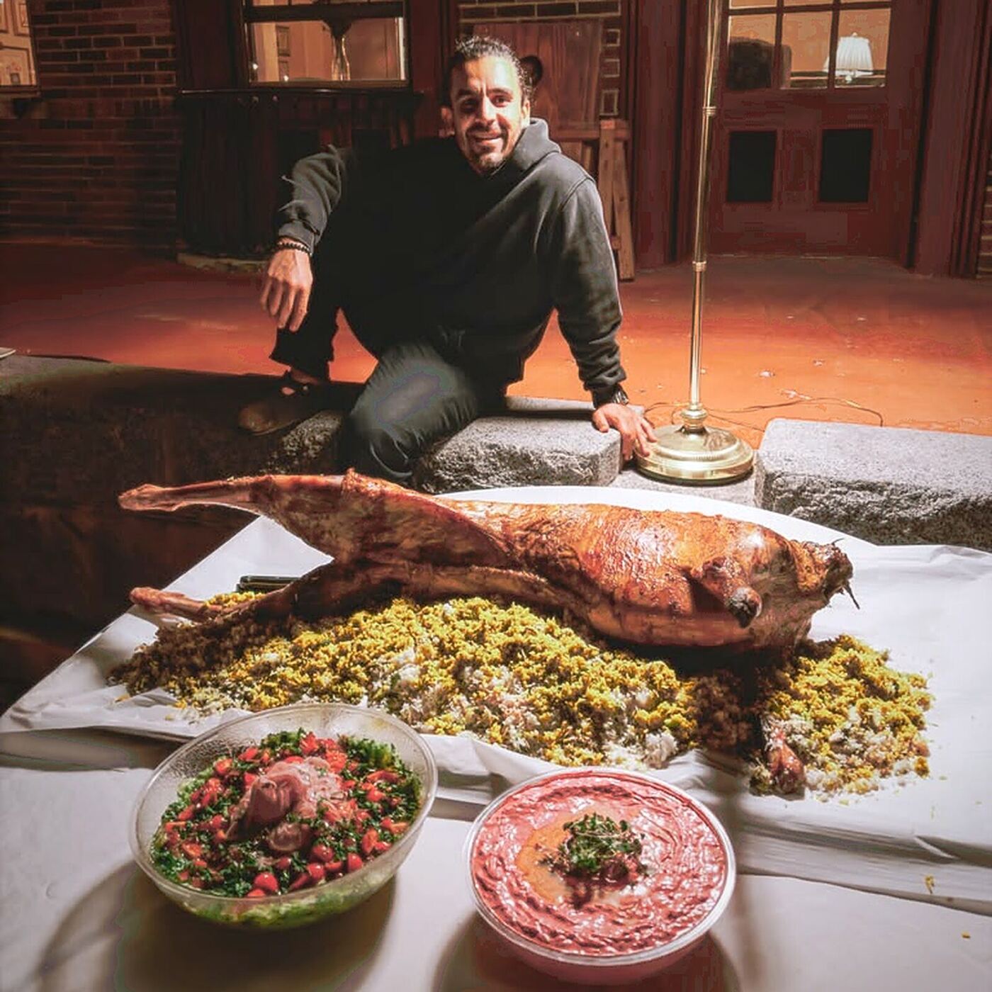 Chef Piaz with a whole roasted lamb over baghali polo