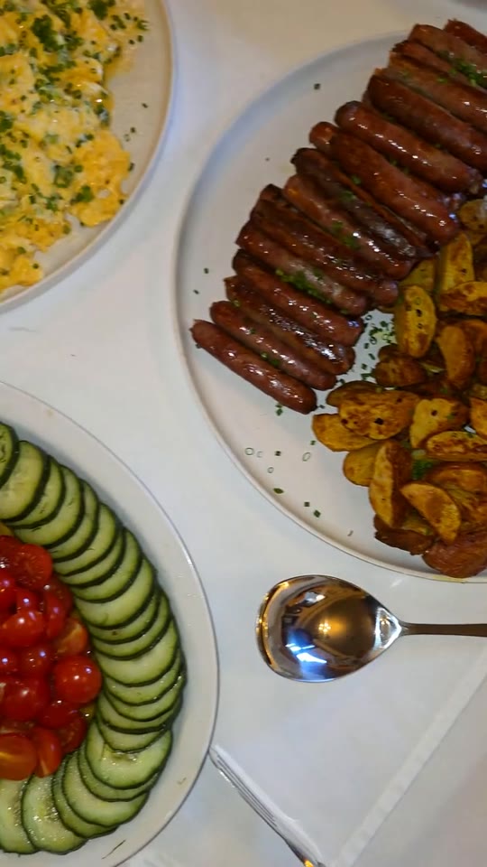 Plates of grilled meats, roasted potatoes and fresh vegetables